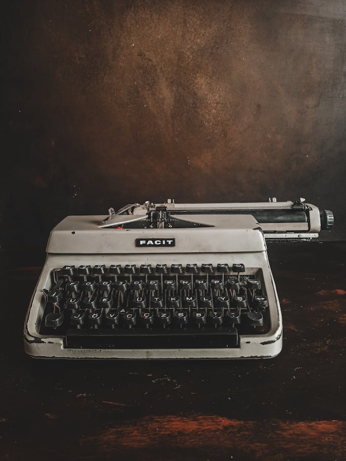 Antique Facit typewriter on a dark wooden surface, captured in a vintage style.