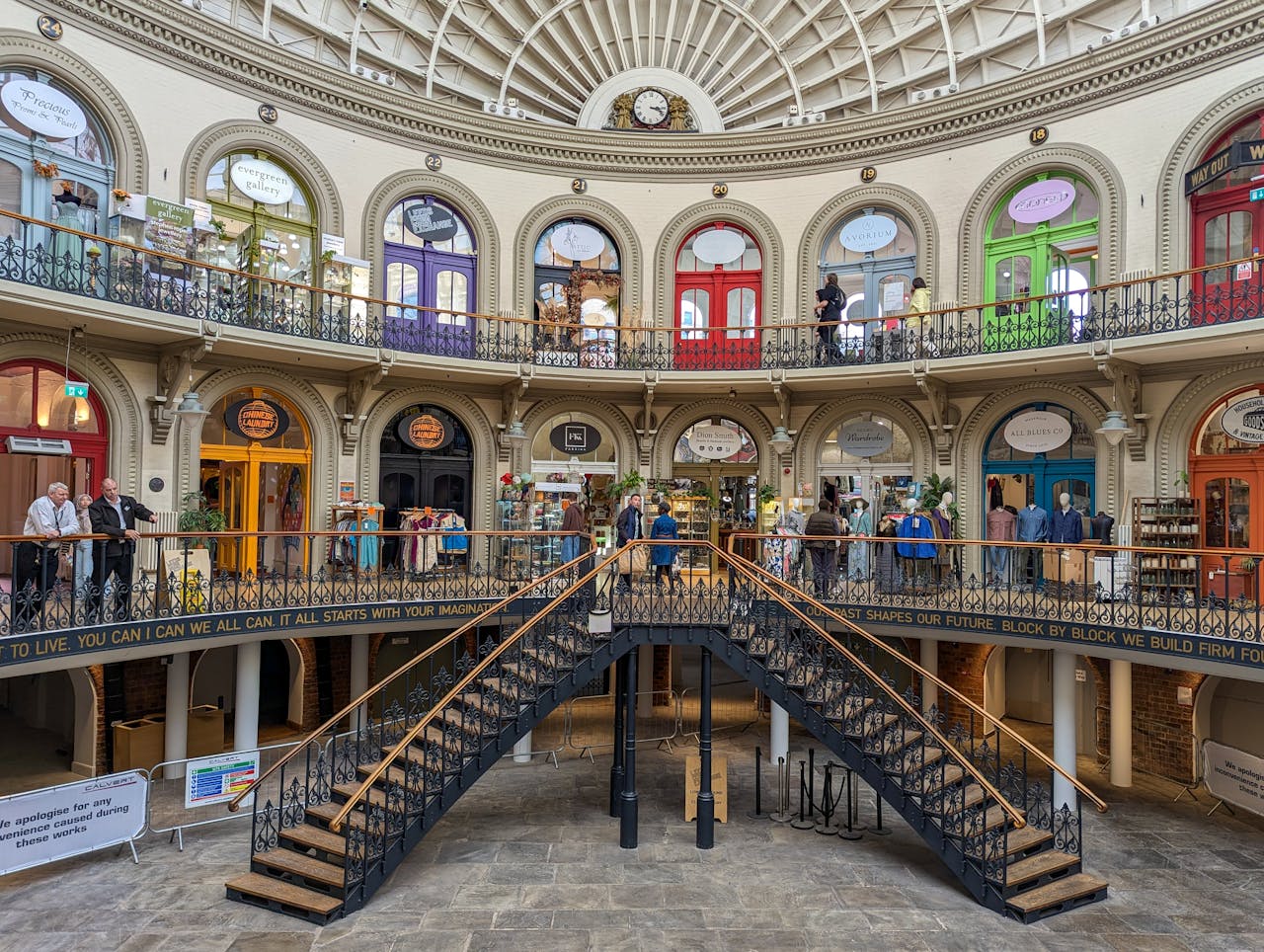 Explore the vibrant interior of the historic Corn Exchange in Leeds, UK, highlighting its colorful Victorian architecture.